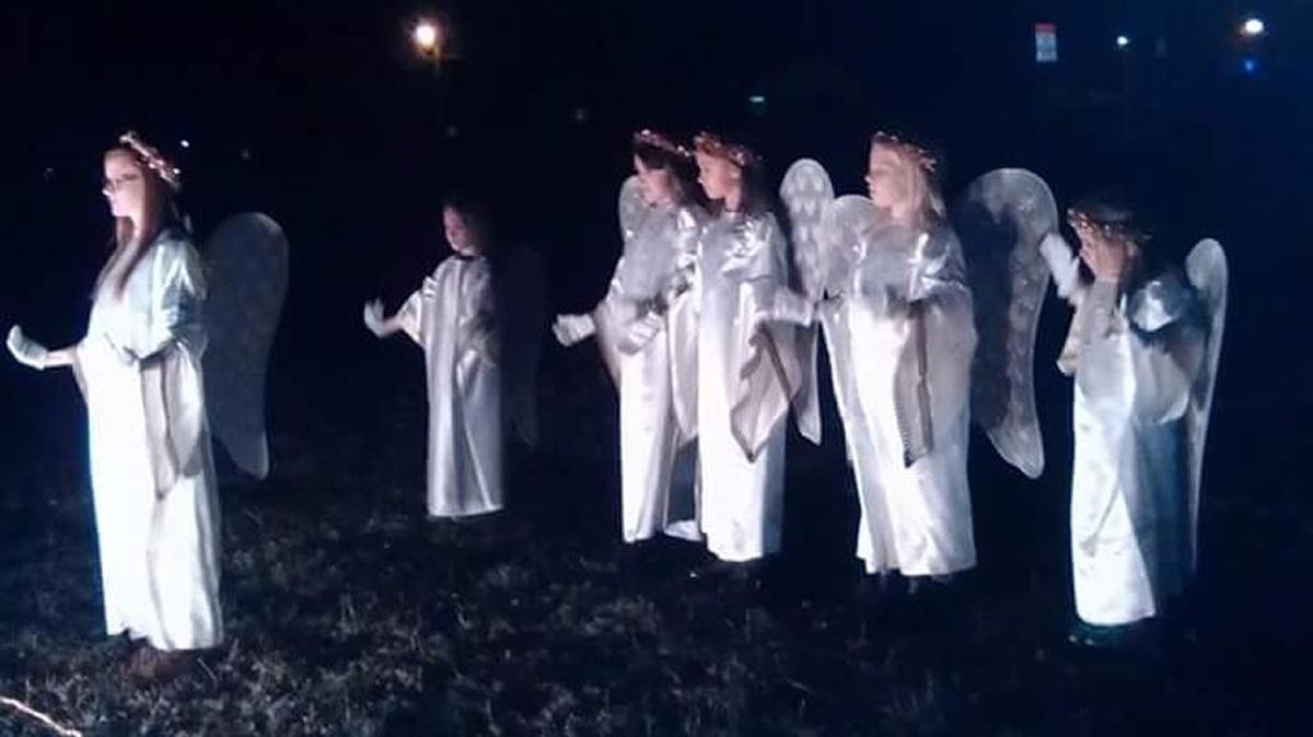 Angels appear in nativity pageant.