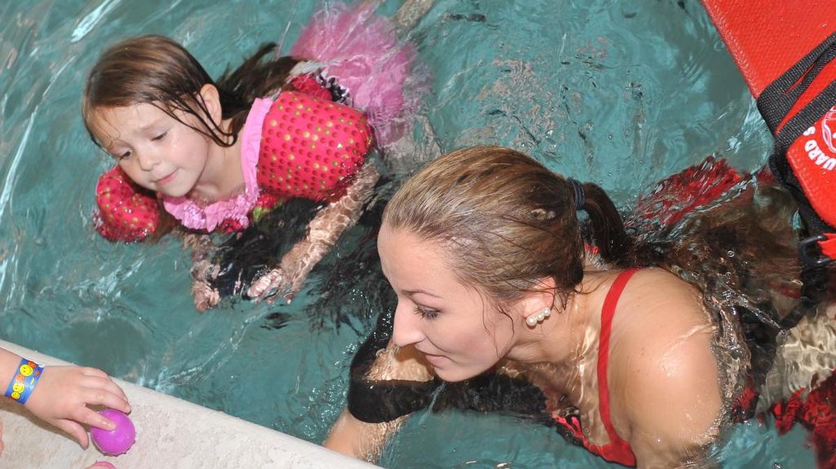 Chloe Caskadden receive help from Lifeguard McKenzie Sanders during an event at the Columbus Aquatic Center in March. The center will be open throughout the holidays.