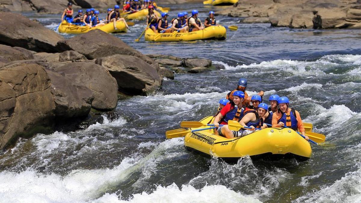 Groups of whitewater rafters negotiate the rapids in the Chattahoochee River in downtown Columbus and Phenix City. Some people like to participate in the adventure, while others simply like to watch, tourism research has found. --