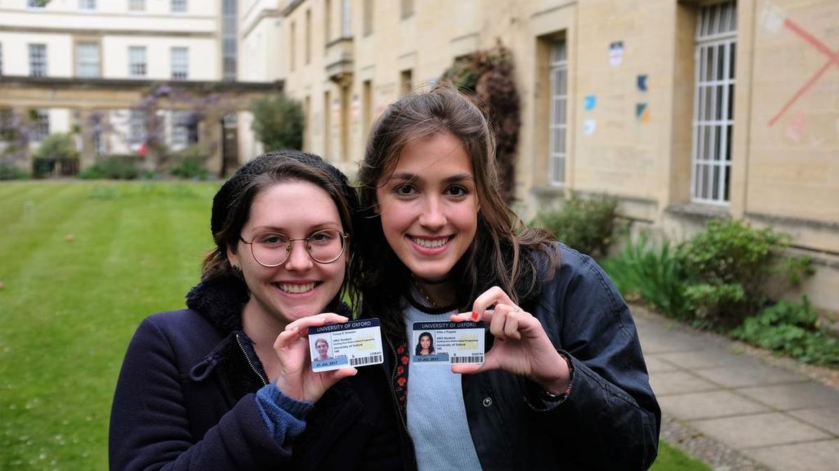 Tonya Streeter, left, and Ellie Pippas with their University of Oxford student ID cards in the courtyard of Regent’s Park College Oxford.