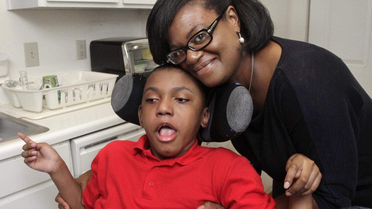 ROBIN TRIMARCHI/rtrimarchi@ledger-enquirer.comLakisha Smith holds her son, Tyree Baker, 12, who has cerebral palsy.