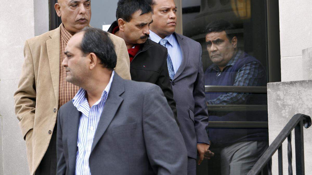 ROBIN TRIMARCHI rtrimarchi@ledger-enquirer.comSawan "Sunny" Shah, second from right, leaves federal court Tuesday surrounded by friends. Shah pleaded guilty to one count of operating an unlisenced money transmitting business.  01.26.16