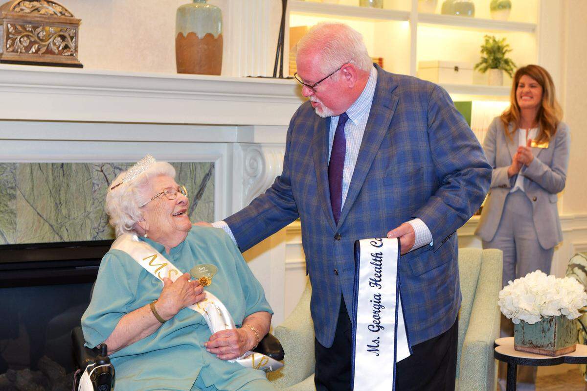 Tony Marshall, President and Chief Executive Officer at Georgia Health Care Association surprises Joy Graham with the news that she is this year’s Ms. Georgia Health Care Association. 09/08/2022