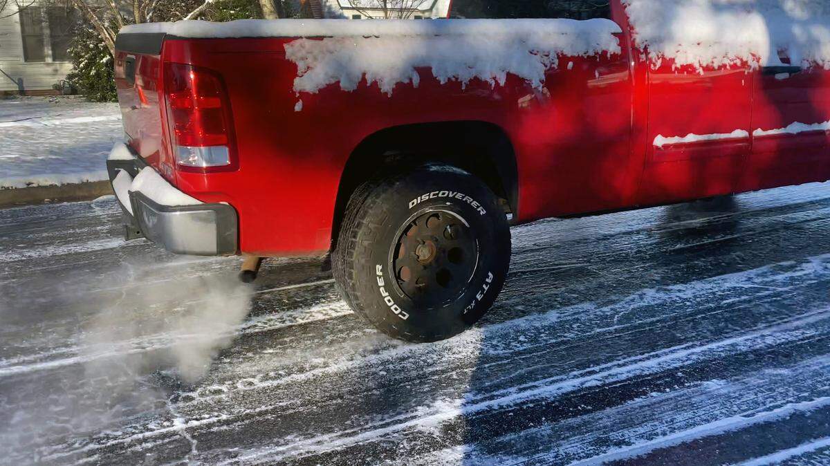 A driver navigates an ice covered road in Columbus’ Jordan-Johnson neighborhood on the morning of Jan. 22, 2025.