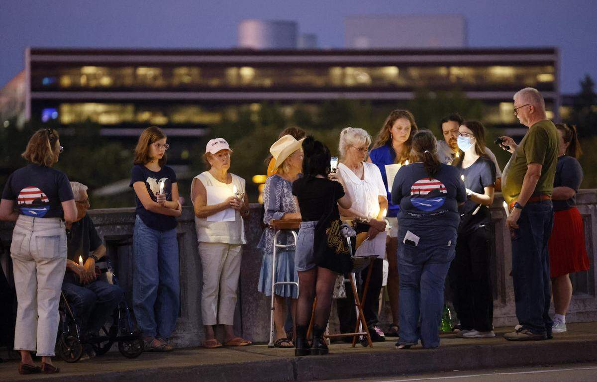 People gather Sept. 4, 2025, on the 13th Street Bridge, which connects Columbus, Georgia, to Phenix City, Alabama, for a candlelight vigil to remember and honor victims of gun violence. The event was organized by Phenix City Indivisible, Columbus, GA Indivisible and the Under the Muscadine Catholic Worker community.