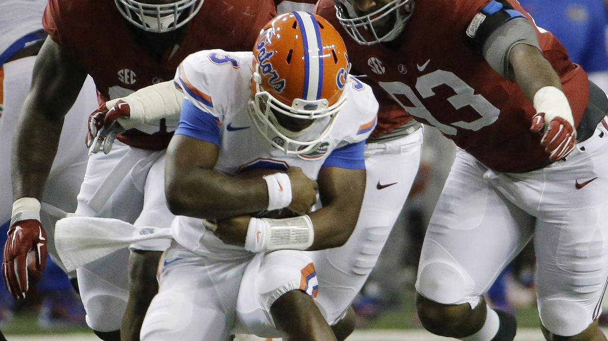 DAVID GOLDMAN/Associated PressFlorida quarterback Treon Harris (3) awaits being sacked by Alabama defensive lineman Jonathan Allen (93) and Alabama defensive lineman A'Shawn Robinson (86) during the first half of the Southeastern Conference championship NCAA college football game Dec. 5 in Atlanta.