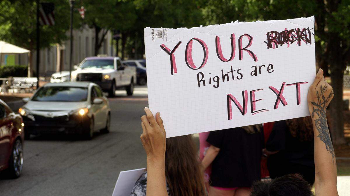 Rio Rivera holds a sign for passing motorists to see while taking part in a Thursday evening protest in downtown Columbus, Georgia against the recent U.S. Supreme Court’s decision about abortion rights. 06/30/2022