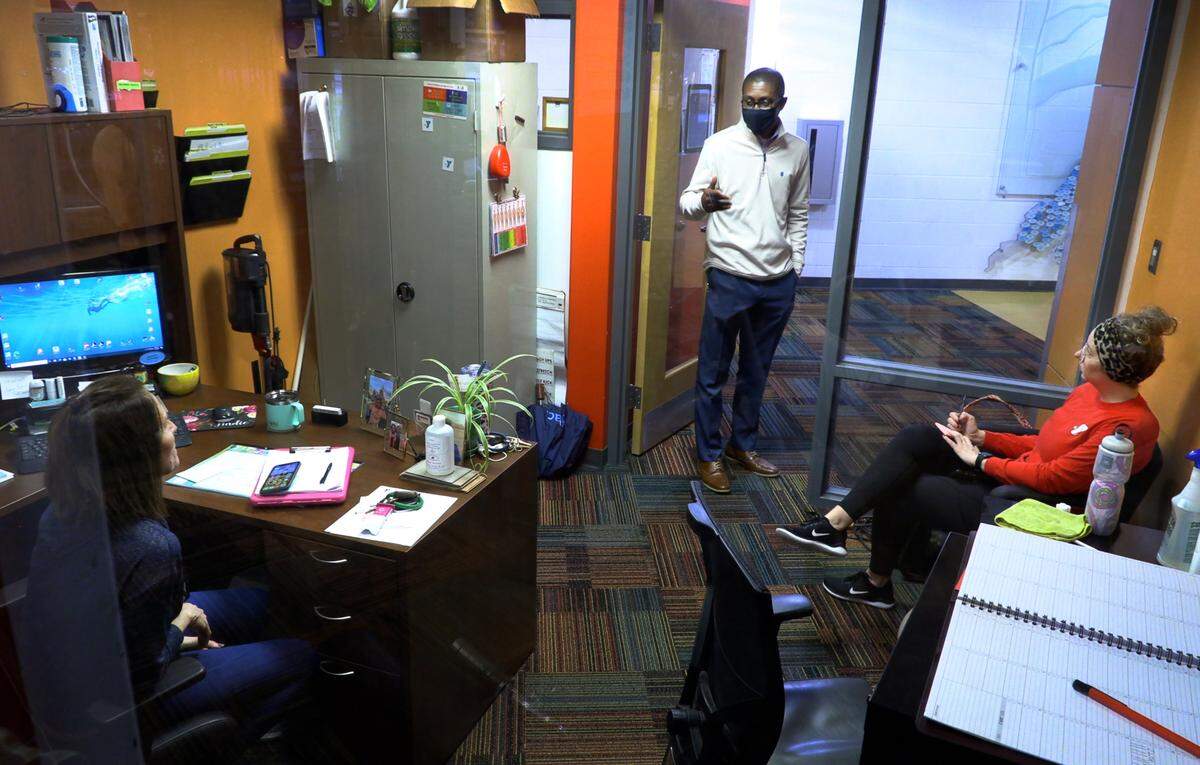 Chris Bryant, center, president and CEO of the YMCA of Metropolitan Columbus in Columbus, Georgia, speaks with staff at the John P. Thayer YMCA in downtown Columbus.