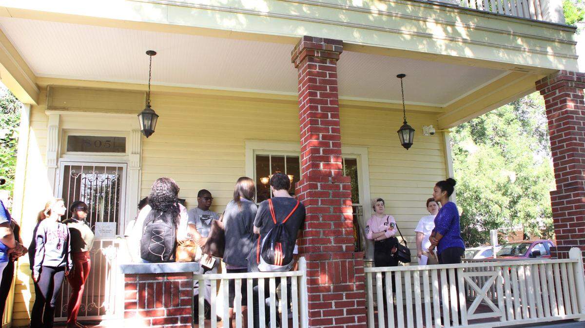 Creative writing Professor Natalia Temesgen talks with students at the Ma Rainey house in Columbus in this 2016 file photo.