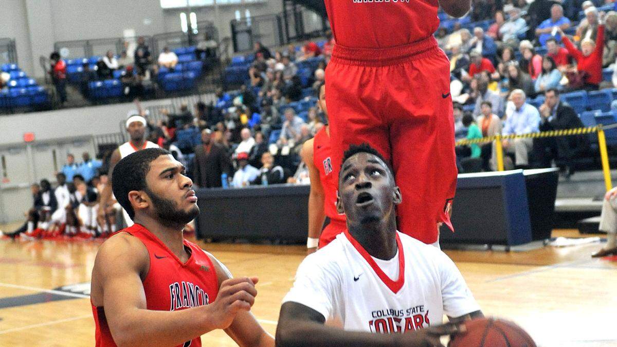 CSU's Demetres Abrams sets up for the shot against Francis Marion's Detrek Browning and Judah Alexander during the first round of the Peach Belt Conference playoffs Sunday.