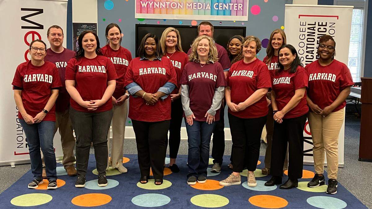 The 2024 class of Harvard Fellows poses for a photo Feb. 28 in the Wynnton Arts Academy library after the Muscogee Educational Excellence Foundation announced these teachers as the recipients of this free week of learning at the Harvard Graduate School of Education.