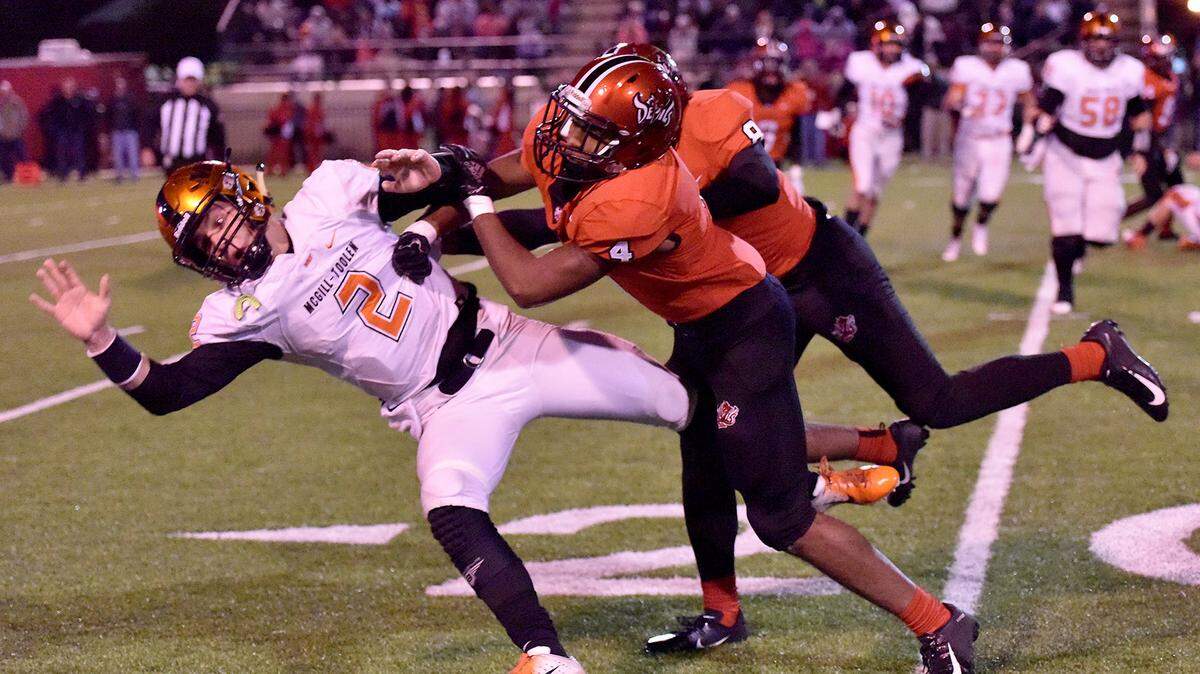 Central’s Xavier Billingsley Jr. and Trevon Miller combine on the tackle of McGill-Toolen quarterback Sheldon Layman, forcing an incomplete pass in the second quarter of their game Friday night, November 16, 2018, in the quarterfinals of the AHSAA state football playoffs at Garrett-Harrison Stadium.