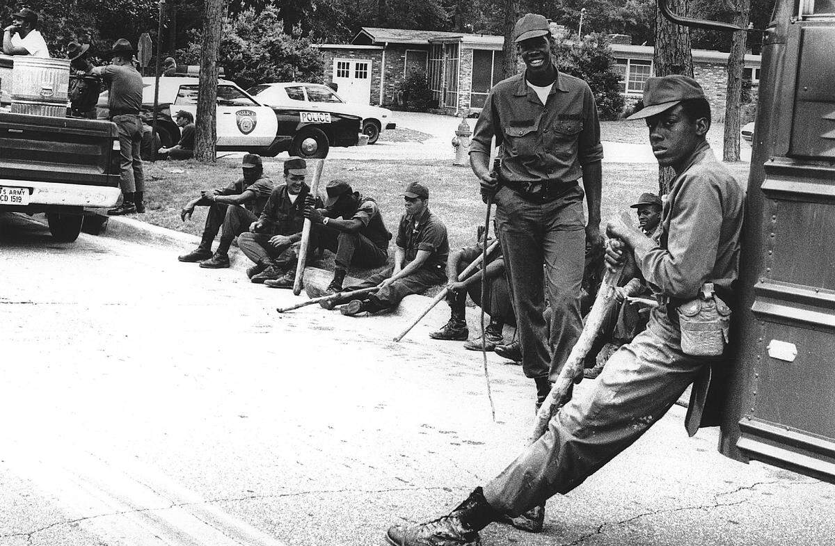 Walker St. Tired Searchers after looking for lost child Tired troops await transportation back to post.