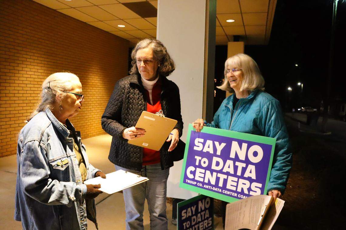 Wanda Lowe, Ila Burdette and Mary Margaret Ware gather outside a city council meeting on Nov. 17 to ask citizens to sign a petition saying no to the proposed data center.