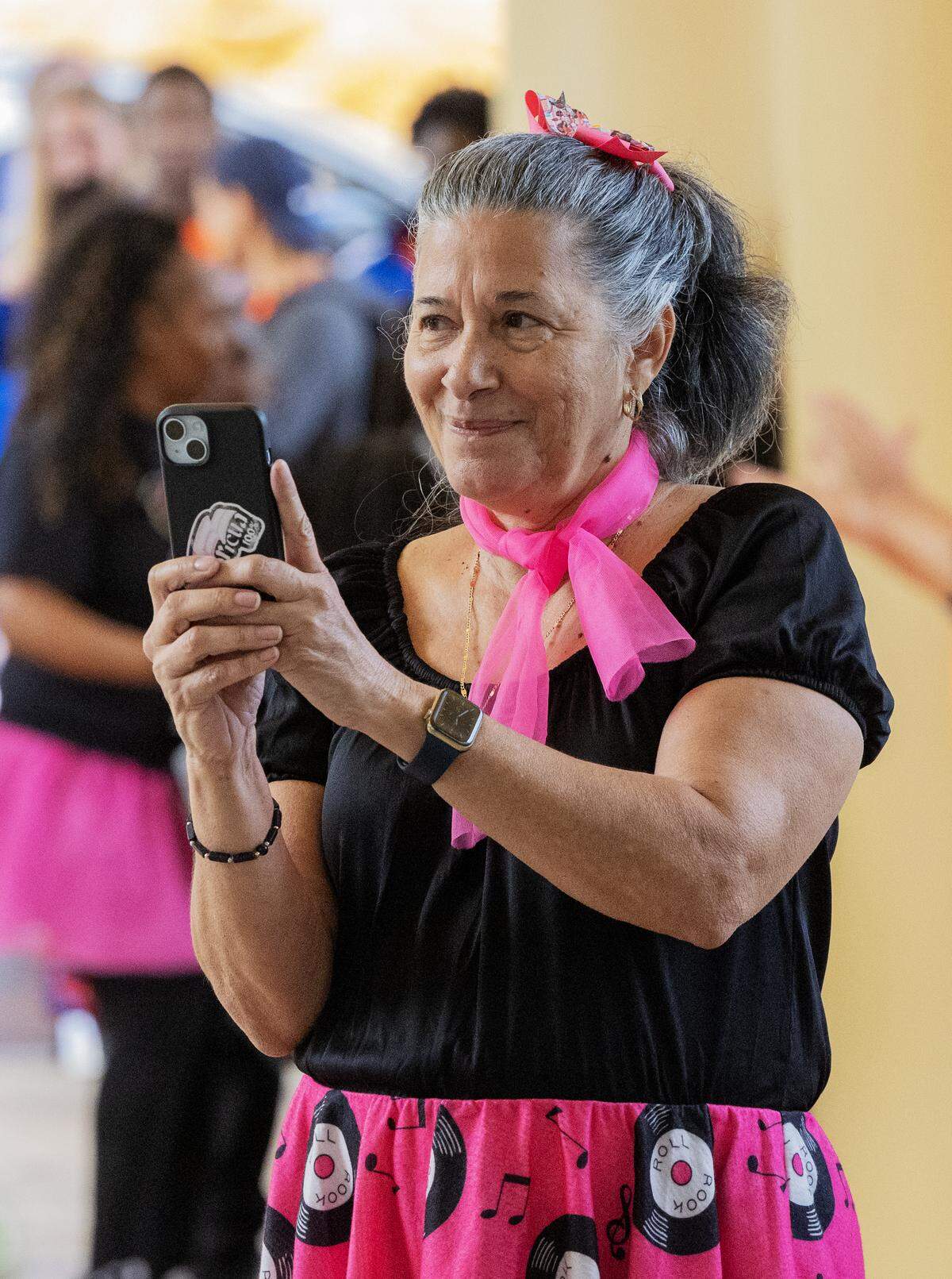 Retired Columbus Councilor Mimi Woodson records the awards ceremony after the Strut the Hooch parade May 2, 2026, in downtown Columbus.