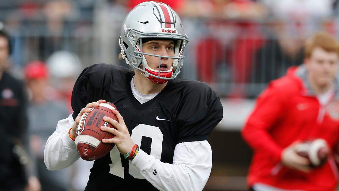 In this April 14, 2018, file photo, Ohio State quarterback Joe Burrow drops back to pass during an NCAA college spring football game in Columbus, Ohio
