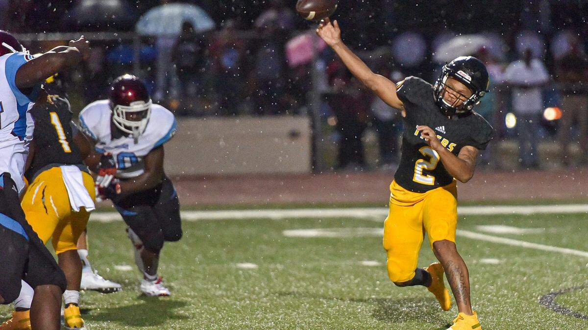 Harris County’s Davion Mahone drops back to pass in the second quarter of the game against Carver, Friday night August 23, 2019.