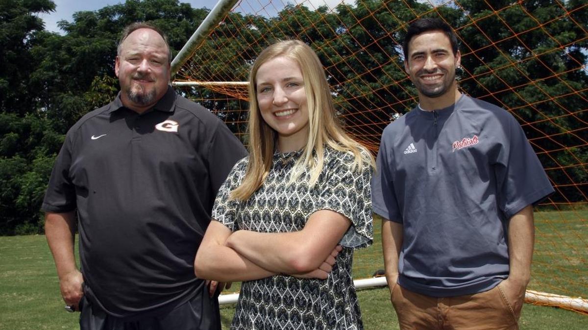 All Bi-City Girls Soccer Player of the Year Kylie Bechard of Harris County High School, center, with Girls Coach of the Year John Robertson of Glenwood School, left, and Boys Coach of the Year Rafael Torres of Northside High School.