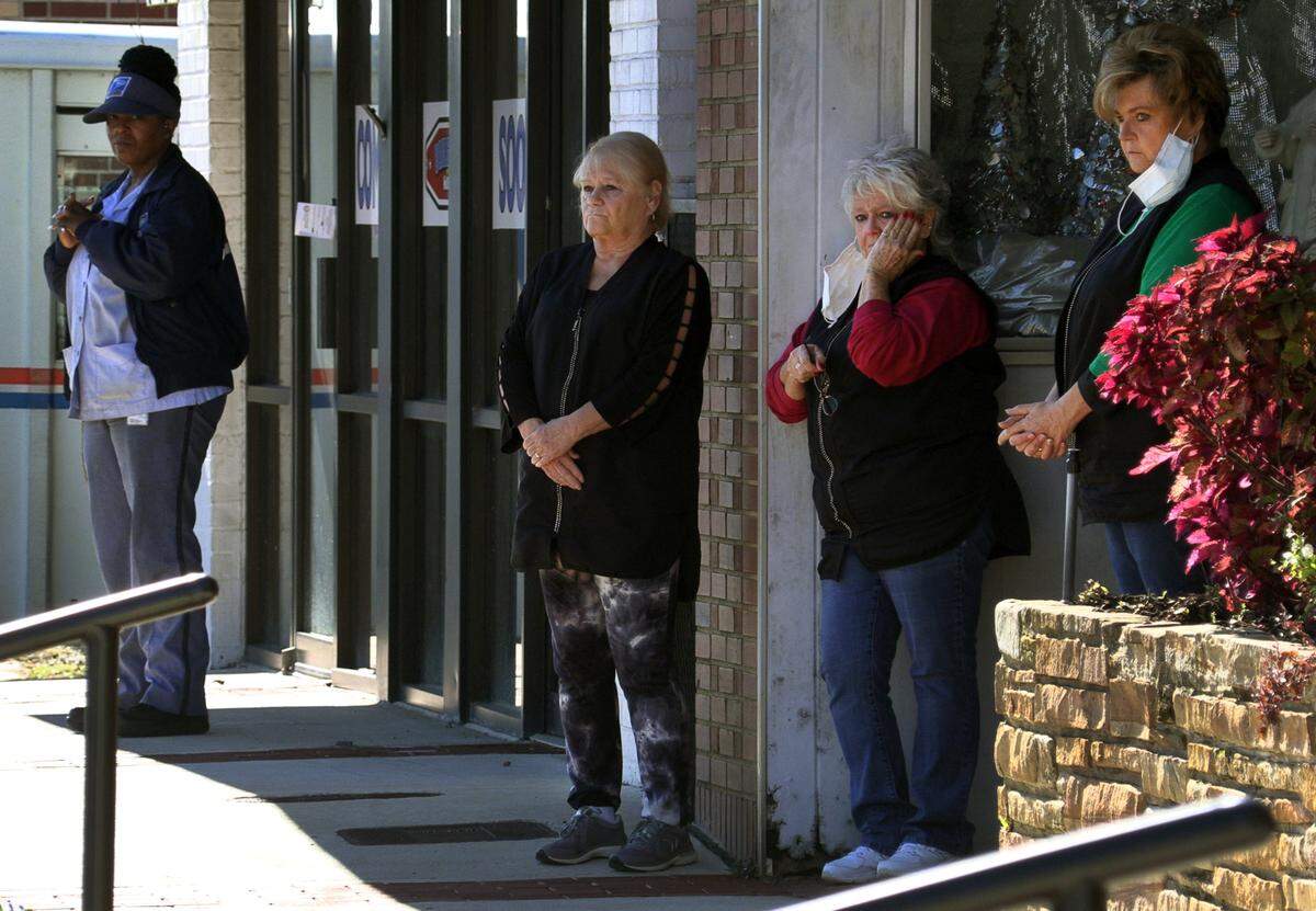 People watch as the funeral procession for Kamarie Holland leaves Taylor Funeral Home in Phenix City, Alabama, Wednesday afternoon.