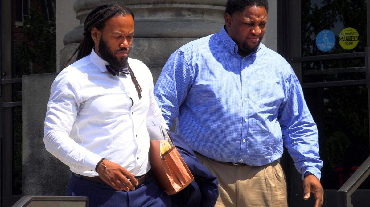 Defense attorney William Kendrick, left, and his client Curtis Porch, 48, right, leave federal court Wednesday afternoon. 06/29/2022