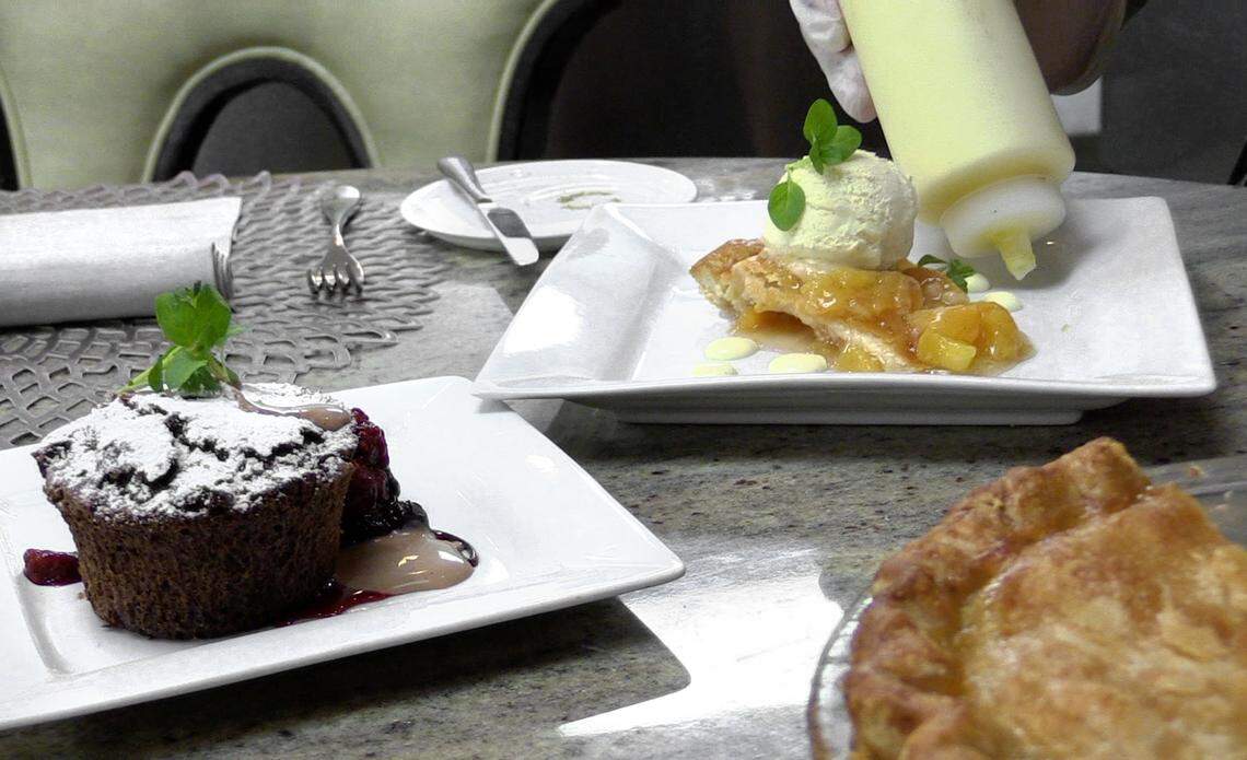 Epic Restaurant Chef Jamie Keating puts the finishing touches on desserts, Chocolate Torte and Peach Pie Ala Mode to top off the lunch menu for Restaurant Week 2018.