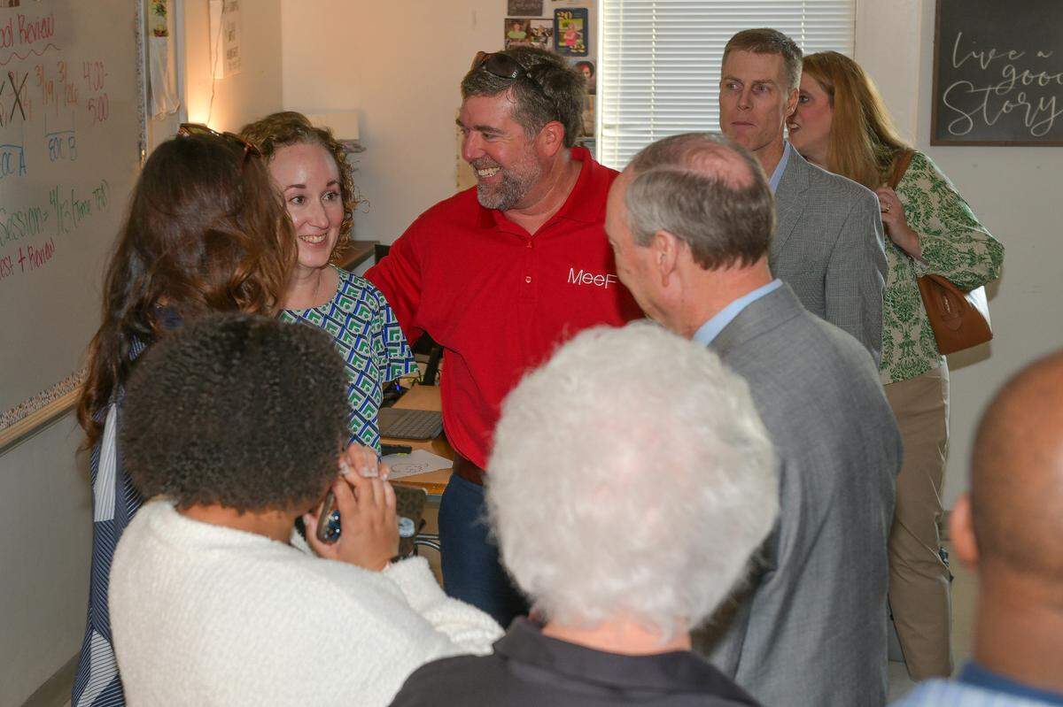 Christie Akers, left, of Northside High School is congratulated by Muscogee Educational Excellence Foundation board members and Muscogee County School District staff members after she was surprised in her classroom March 14, 2024, with the announcement that she is one of the three finalists for the MCSD Teacher of the Year award.