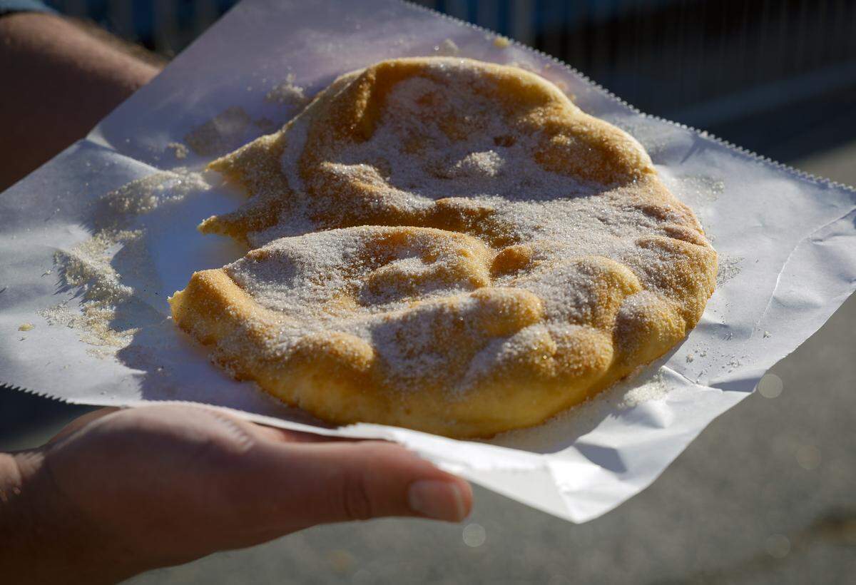 Ledger-Enquirer reporter Kelby Hutchison sampled the elephant ears April 7, 2026, during the Spring Fling at the Columbus Civic Center.