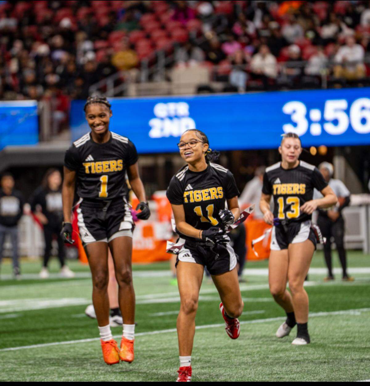 Harris County sophomore defensive back Rylee Hall (11) celebrates a sack during the Georgia High School Association Division 1 flag football state championship game Dec. 15, 2015, at Mercedes-Benz Stadium in Atlanta. The Tigers beat Washington County 32-0 to win the title. Harris County senior safety Kyndle Robinson (1) and junior linebacker Addison Fowler (13) also are pictured.