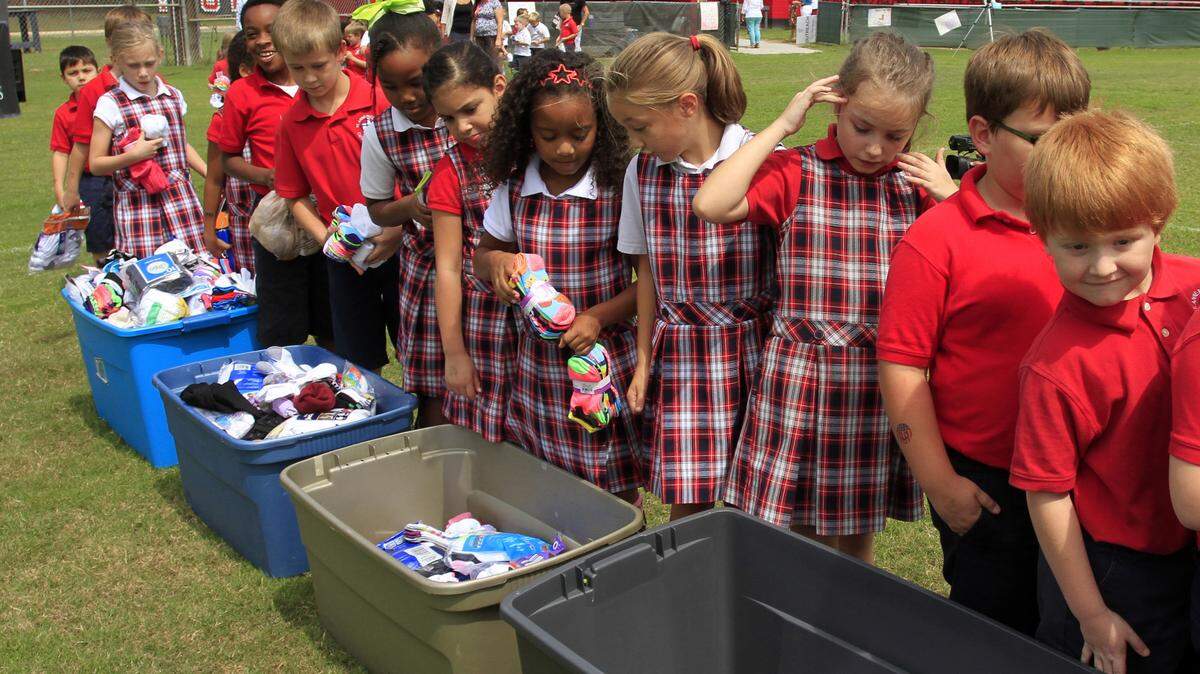 Mike Haskey mhaskey@ledger-enquirer.com 
 Students from St. Anne-Pacelli Catholic School drop off donated socks Tuesday afternoon during the school-wide Sock Hop. Students have been collecting new and gently-used socks since mid-August for St. Anne Community Outreach, which is celebrating its 35th anniversary. St. Anne Community Outreach is a ministry of St. Anne Catholic Church whose primary mission is to provide food and clothing to those in need or in emergency situations. 09/15/15