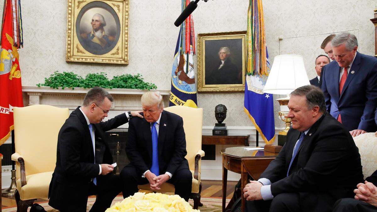 President Donald Trump prays with American pastor Andrew Brunson in the Oval Office of the White House in Washington on Oct. 13. Brunson had returned to the U.S. after he was freed from nearly two years of detention in Turkey.