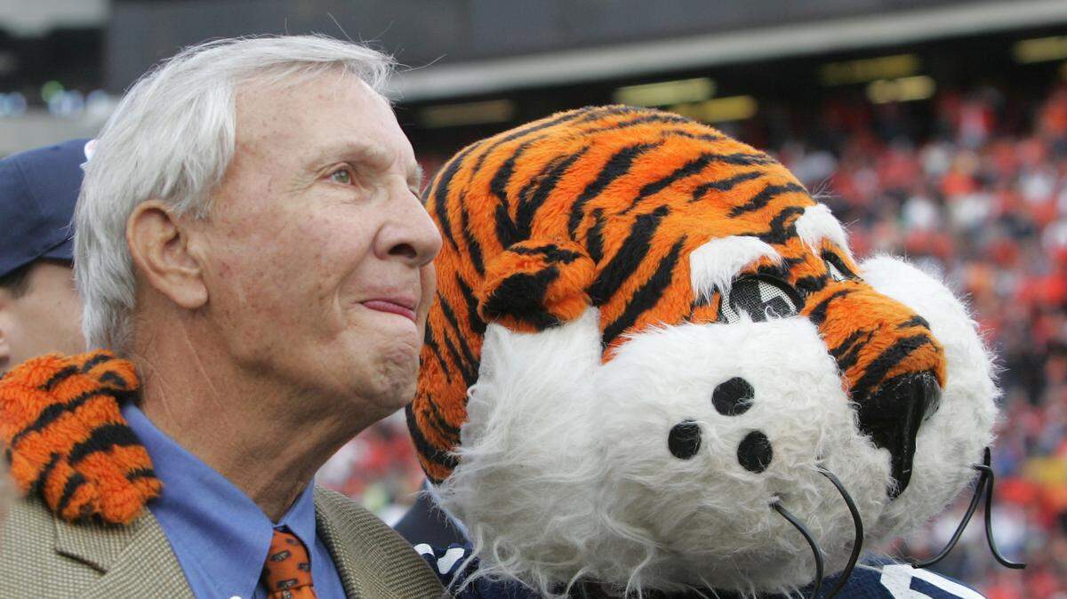 Former Auburn coach Pat Dye watches with Auburn’s mascot a video tribute to his career before the start of the Iron Bowl against Alabama, Saturday Nov. 19, 2005 in Auburn, Ala. The school re-named the playing field after him.