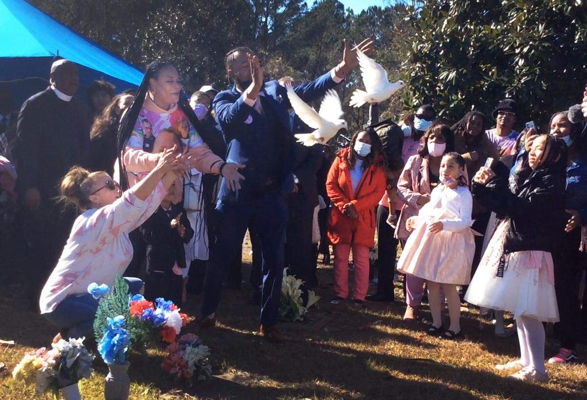 Kamarie Holland’s family members release two doves at her gravesite Wednesday morning.