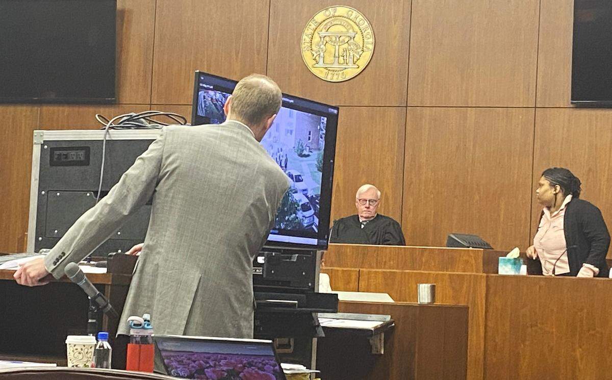 Prosecutor Thomas Kegley shows witness Elysia Cooley surveillance video from Wilson Homes, where an alleged Crips gang gathering occurred on June 5, 2021.