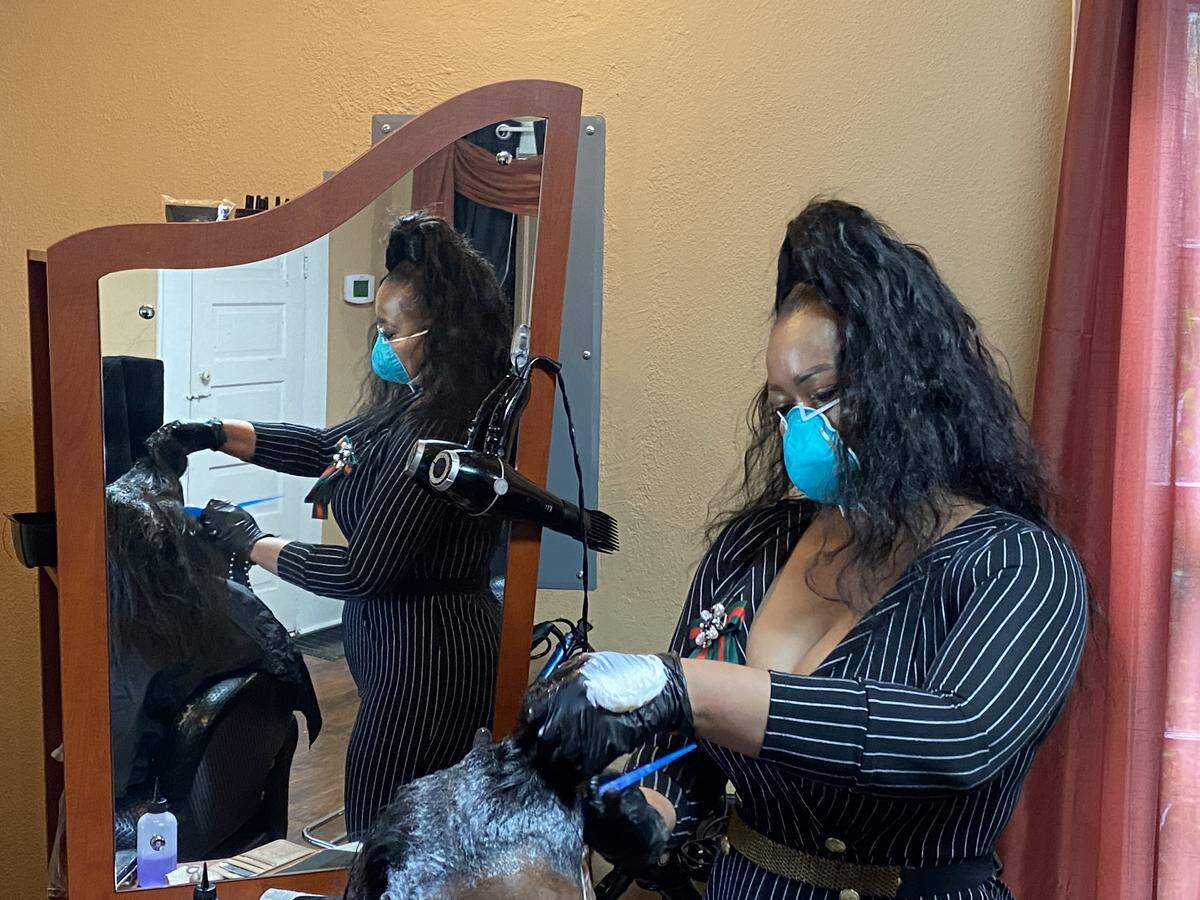 Marsha’s Lavish Beauty Salon owner Marsha Berry works on a client’s hair on April 24, the first day Georgia hair salons, barber shops and other cosmetology-related businesses were allowed to open since Governor Brian Kemp issued a shelter in place order beginning April 3.