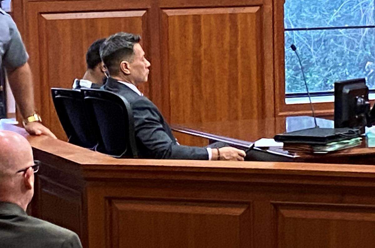 Defense attorney Allen Jones, center, sits in court with double-homicide suspect Damon Daniels Jr.