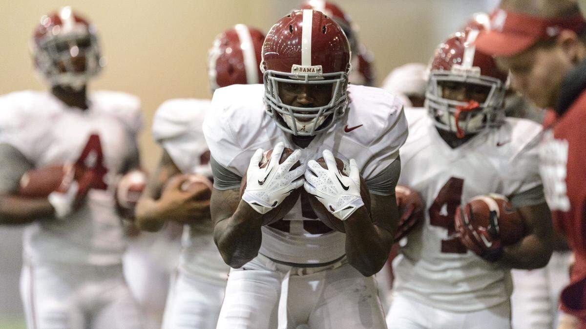 VASHA HUNT/Associated PressAlabama running back Bo Scarbrough works through drills during practice Dec. 21, 2014, at the Hank Crisp Indoor Facility in Tuscaloosa, Ala. Scarbrough and Damien Harris are likely to battle for the starting job at running back.