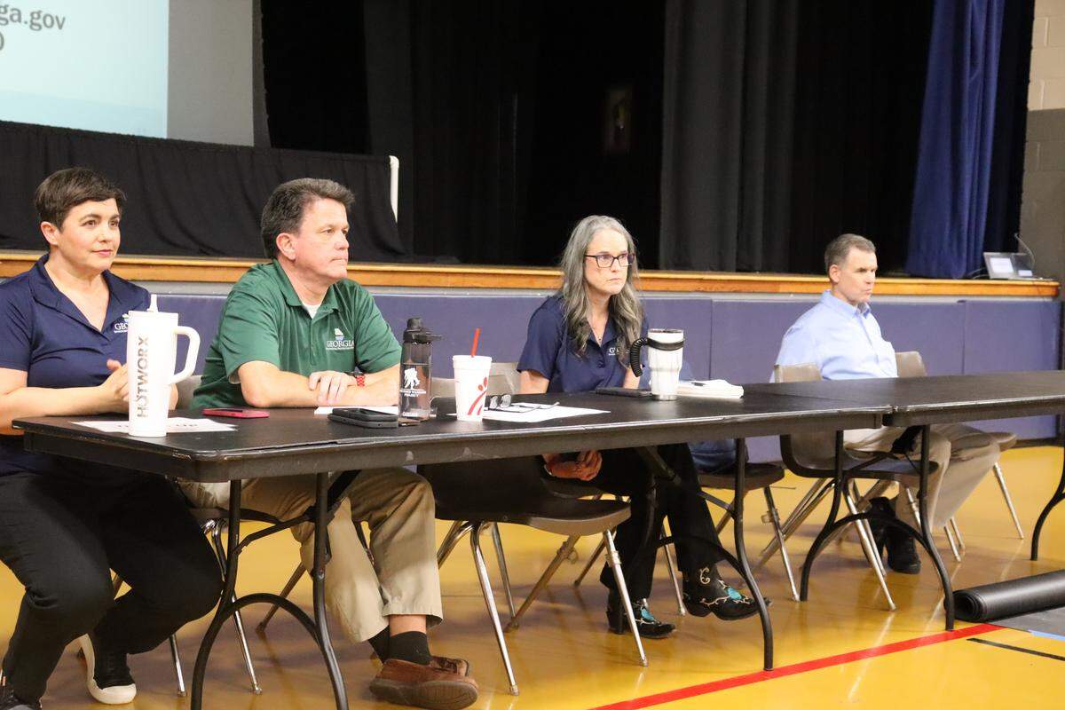 Georgia Environmental Protection Division employees listen May 18, 2026, in the Thomaston Civic Center to Upson County residents speak about Brightmark’s draft air permit. They are, from left, Anna Aponte, manager of the Planning and Regulatory Development Unit; Steve Allison, manager of the Stationary Source Permitting Program; Wendy Troemel, manager of the Chemical Permitting Unit; and James Boylan, chief of the Air Protection Branch.