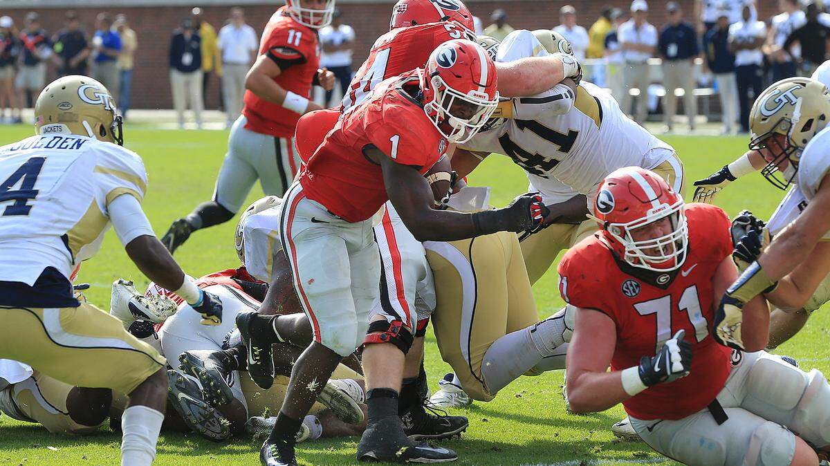 Georgia tailback Sony Michel (1) finds some running room past Georgia Tech defender Jamal Golden during the second half of an NCAA college football game Saturday, Nov. 28, 2015, in Atlanta. (Curtis Compton/Atlanta Journal-Constitution via AP) MARIETTA DAILY OUT; GWINNETT DAILY POST OUT; LOCAL TELEVISION OUT; WXIA-TV OUT; WGCL-TV OUT; MANDATORY CREDIT