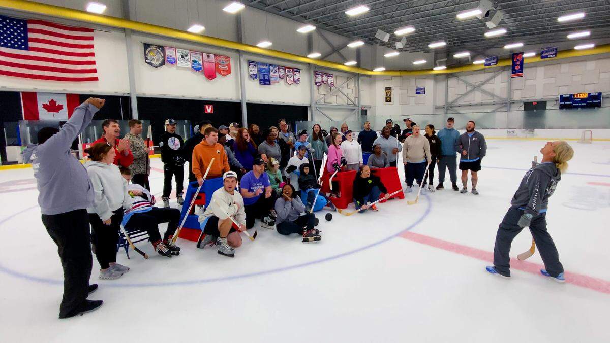 Camp Abilities director Jeanine Fittipaldi-Wert, right, associate professor of health & physical education at Columbus State University, leads campers and volunteers in a cheer at the Columbus Ice Rink, pictured May 23, 2026.