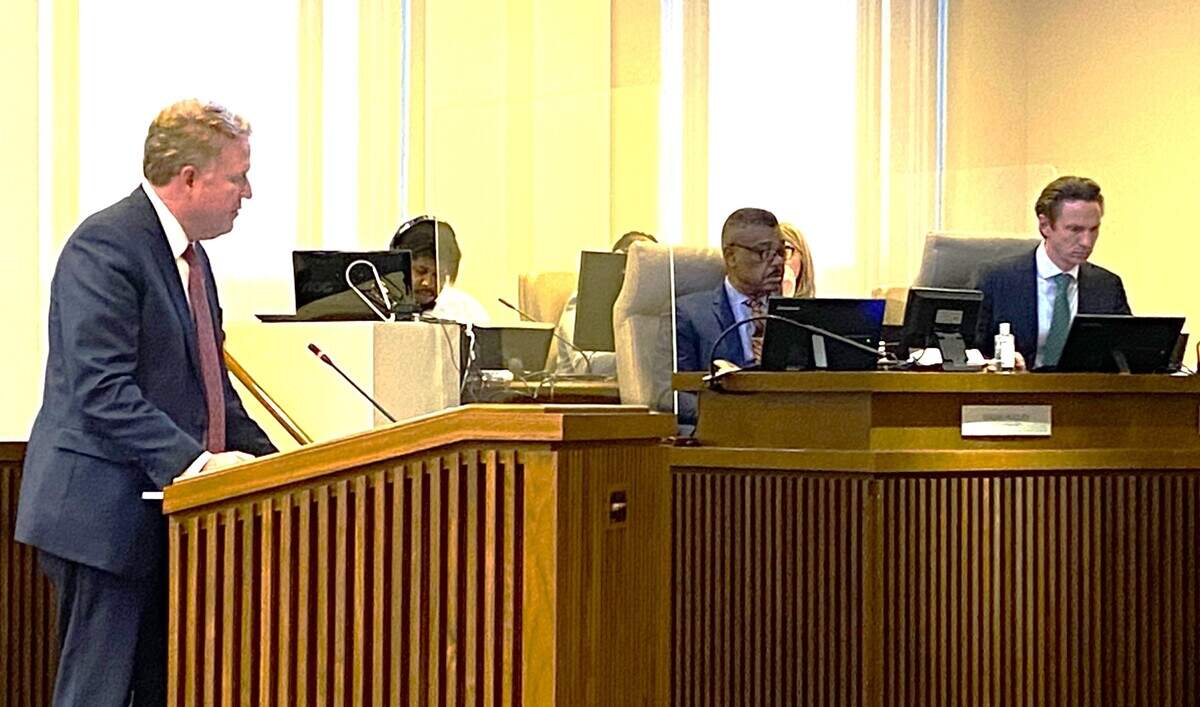 City Manager Isaiah Hugley, center, listens as attorney Charlie Peeler of the Atlanta law firm Troutman Pepper reports on his investigation into city finances.