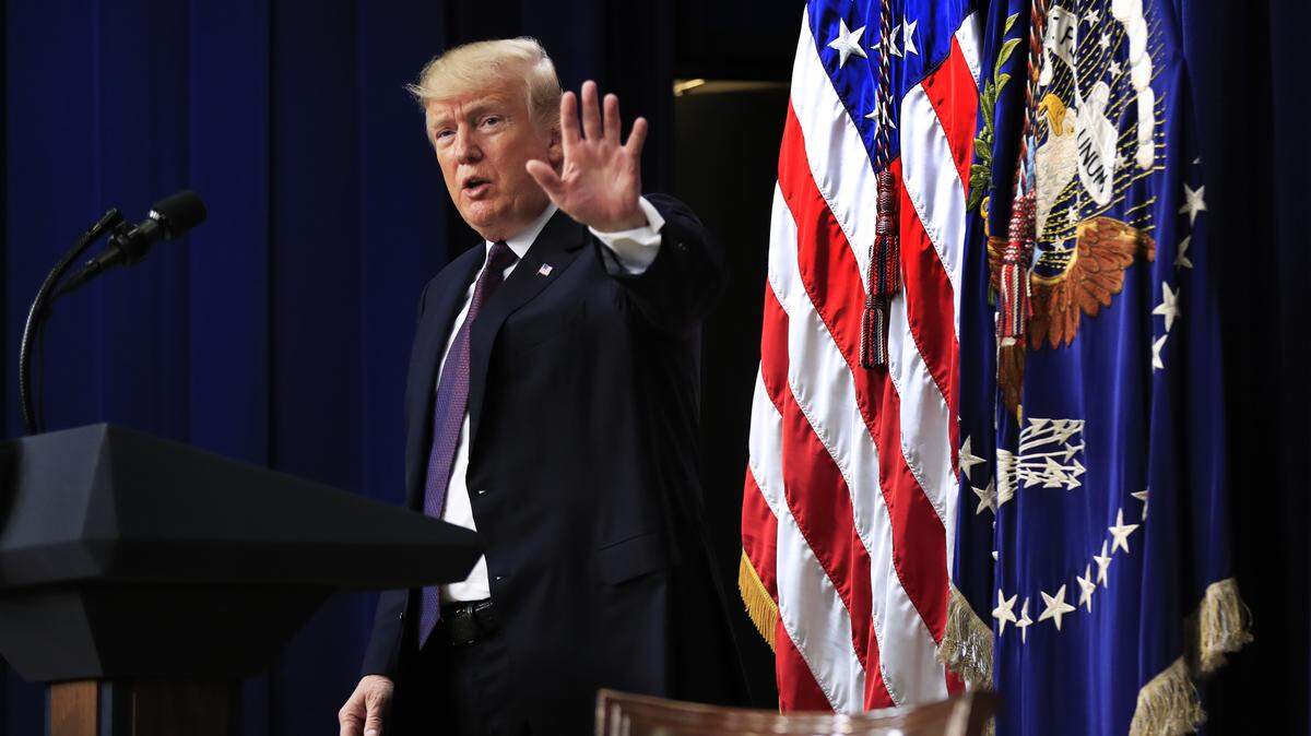 President Donald Trump acknowledges the applause during a conference supporting veterans and military families through partnership at the Eisenhower Executive Office Building on the White House complex in Washington on Thursday.