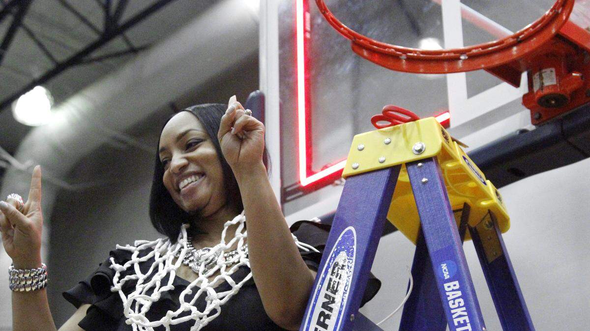 Columbus State University Lady Cougars head coach Anita Howard drapes the net around her neck as her team celebrates its 86-75 win over Lincoln Memorial in the NCAA Southeast Regional championship game in the Lumpkin Center Monday. The team will head to Columbus, Ohio for the NCAA Division II Elite Eight.