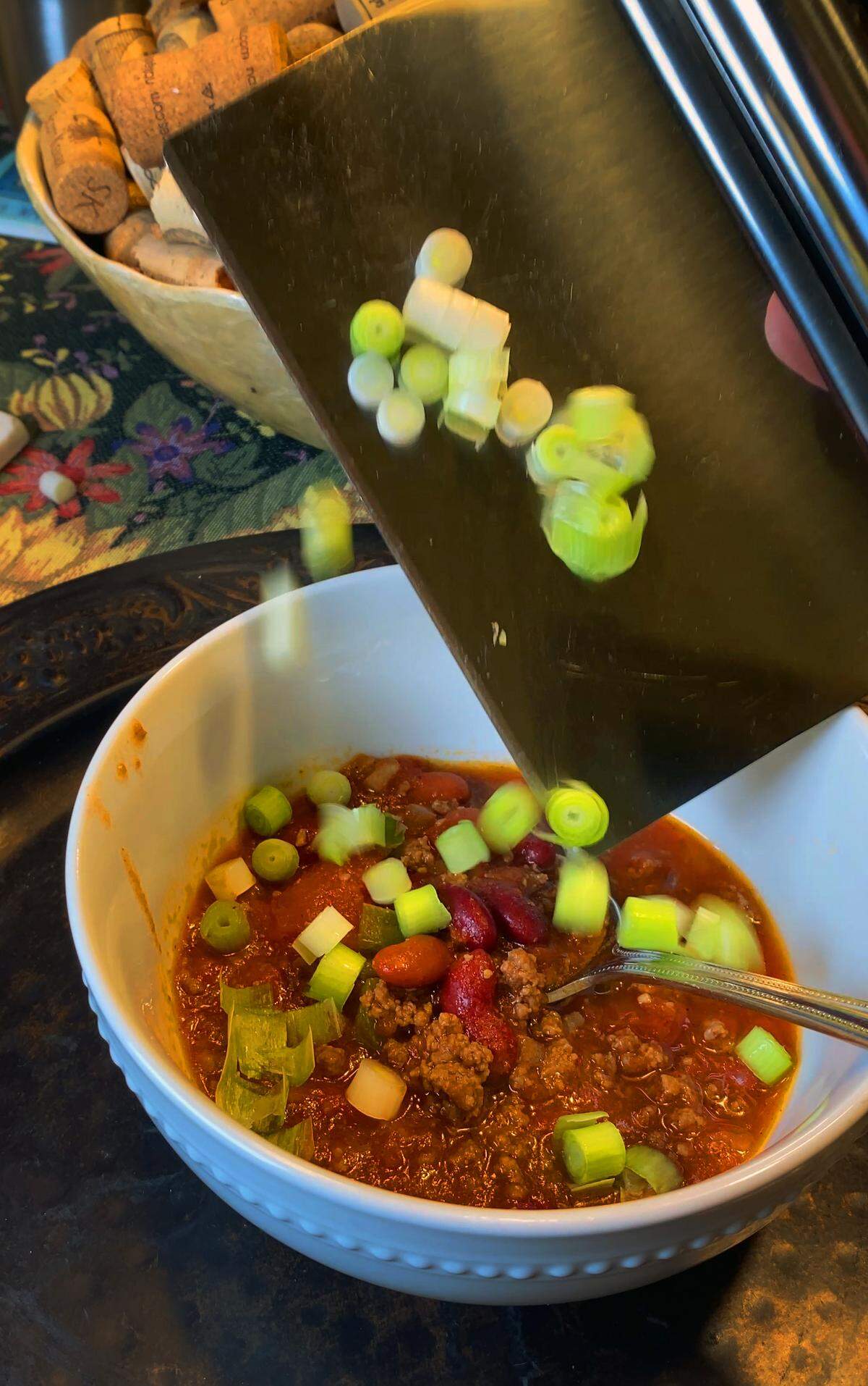Peter Bowden, retired president and CEO of VisitColumbusGA, puts the finishing touches on a bowl of Christmas chili while cooking in his kitchen Dec. 10, 2025.
