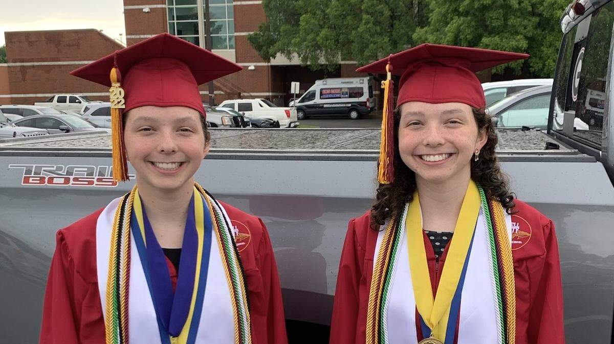 Twin sisters Kelli, left, and Emily Angel pose at the Columbus Civic Center, where they gave the valedictorian and salutatorian speeches during the Russell County High School graduation ceremony May 25, 2022.