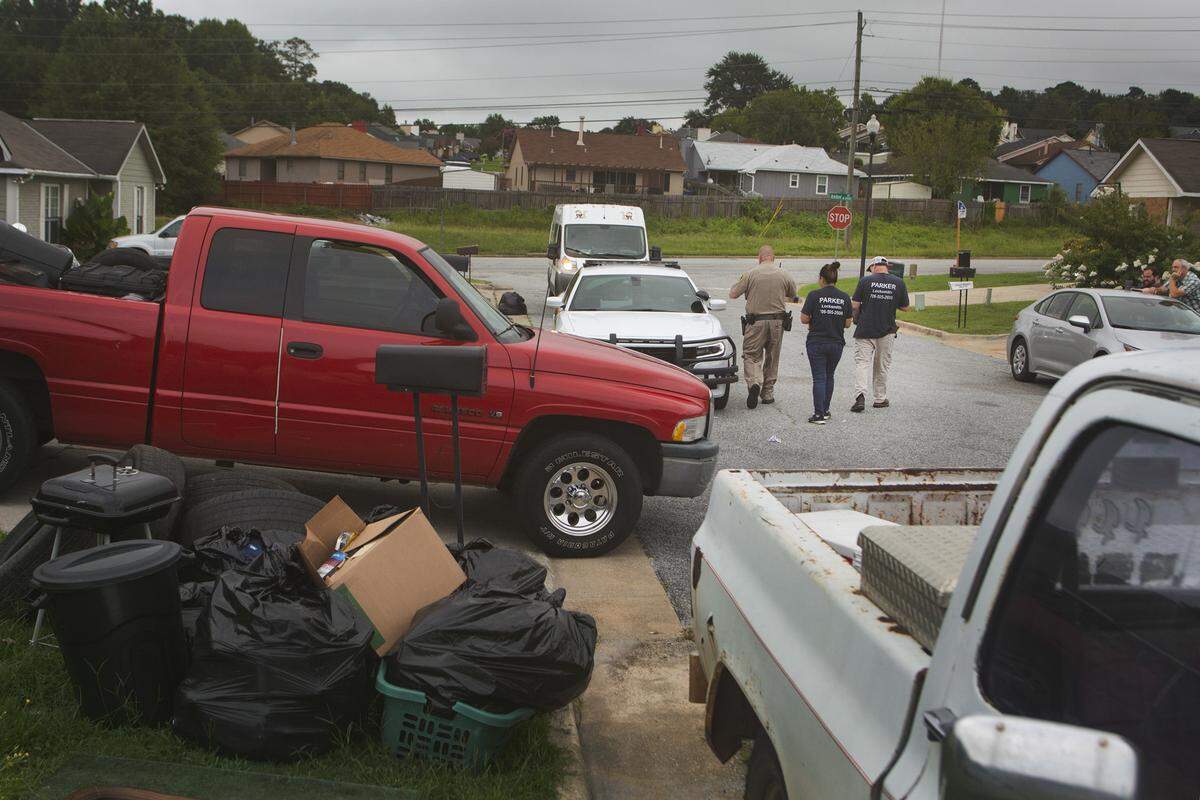 Deputy David Podger and two key smiths leave the scene after an eviction on July 20, 2021, in Columbus, Ga.