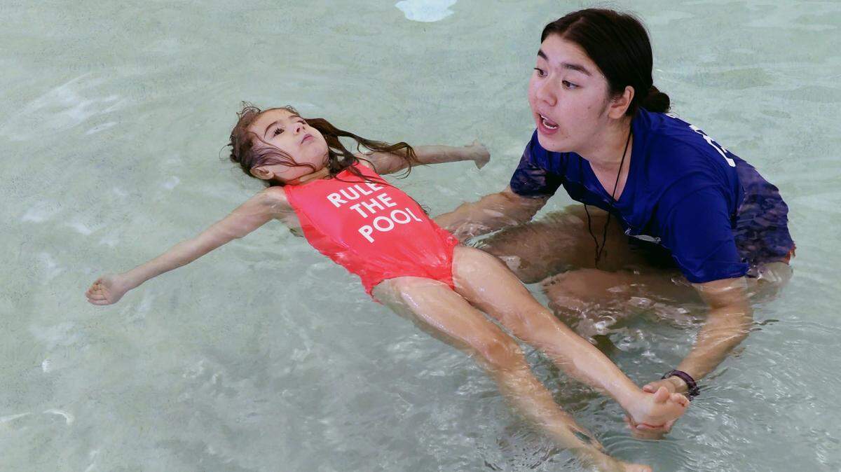 Swimming instructor and lifeguard Emily King teaches a swimming class to young children Wednesday morning at the Harris County Community Center in Hamilton.