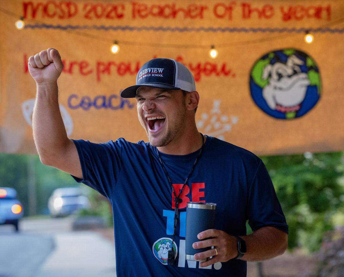 Clubview Elementary School physical education teacher Chris Grier greets students arriving for school May 8, 2026, the day after the Muscogee Educational Excellence Foundation named him the 2026 Teacher of the Year in the Muscogee County School District.