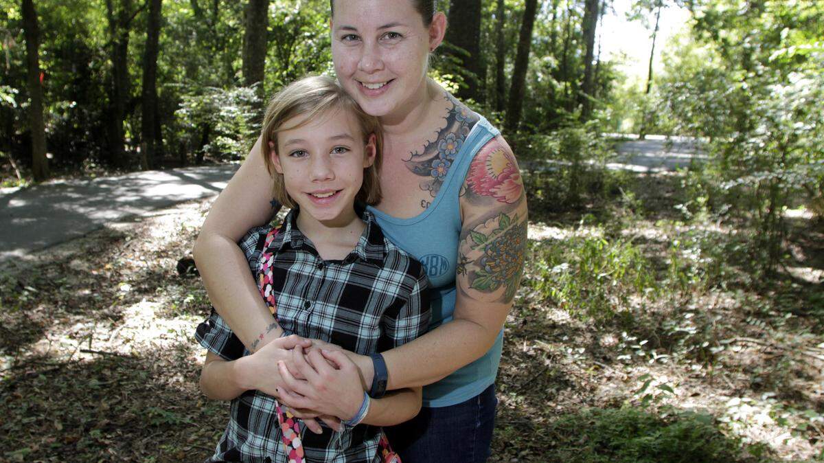 Photos by ROBIN TRIMARCHI/rtrimarchi@ledger-enquirer.comKrysten Burch and her daughter Cadence, 11, will walk the trails around the Oxbow Meadow Environmental Learning Center during the JDRF One Walk to cure type 1 diabetes. Cadence, a sixth-grader at Faith Middle School, wears an insulin pump and carries a glucose test kit to control the autoimmune disorder.