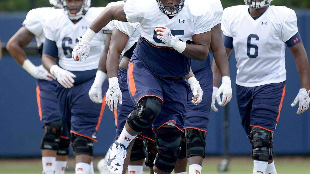 JULIE BENNETT/AL.com via APAuburn defensive lineman Dontavius Russell (95) runs through drills during practice Friday at the Auburn Athletic Complex in Auburn, Ala.
