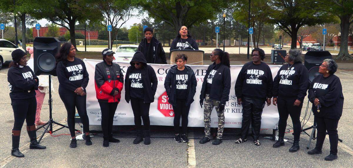 Shirley Davis, president of 100 Women on the Move Inc., speaks with participants in the “Stop the Violence Motorcade” event after they returned to the Columbus Civic Center.